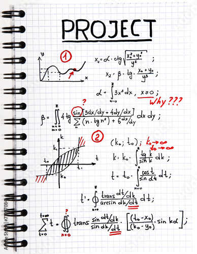 Notepad with a mathematical project with red marks