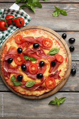 Delicious pizza served on wooden table