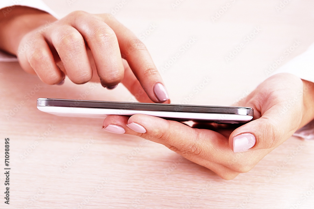 Woman using smartphone on light background Woman using smartphone on light background