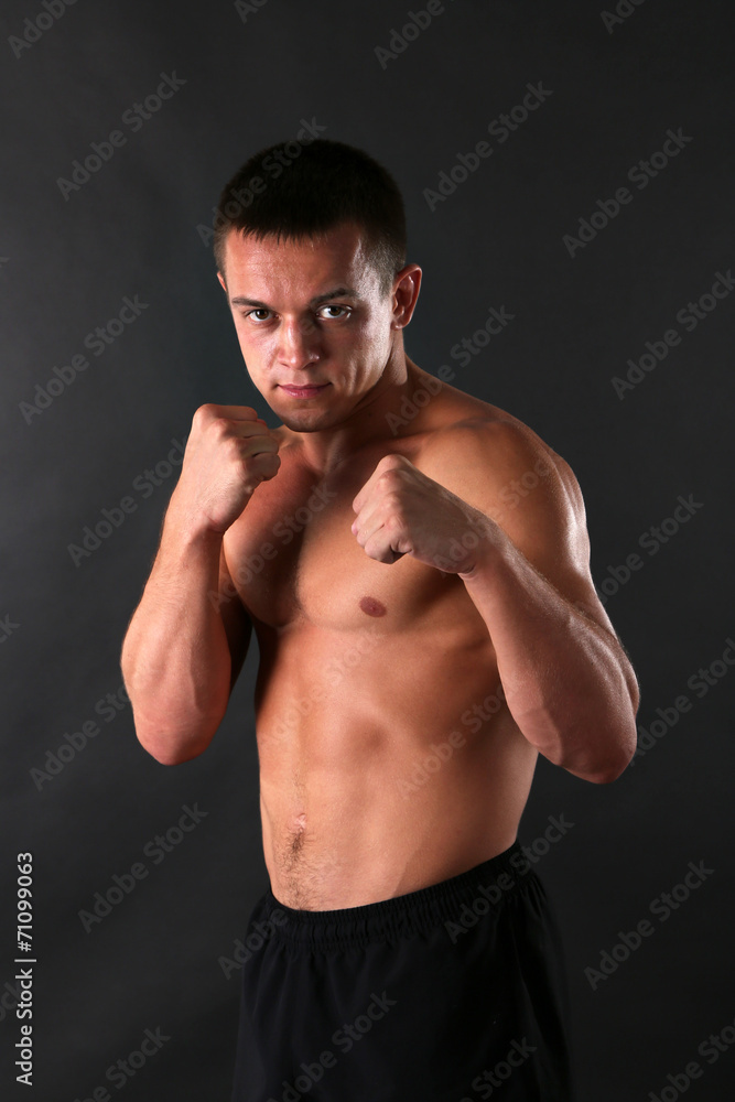 Handsome muscle young man on dark background Handsome muscle young man on dark background