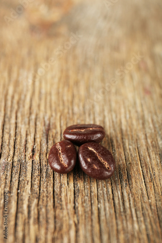 Coffee beans with chocolate glaze on wooden background