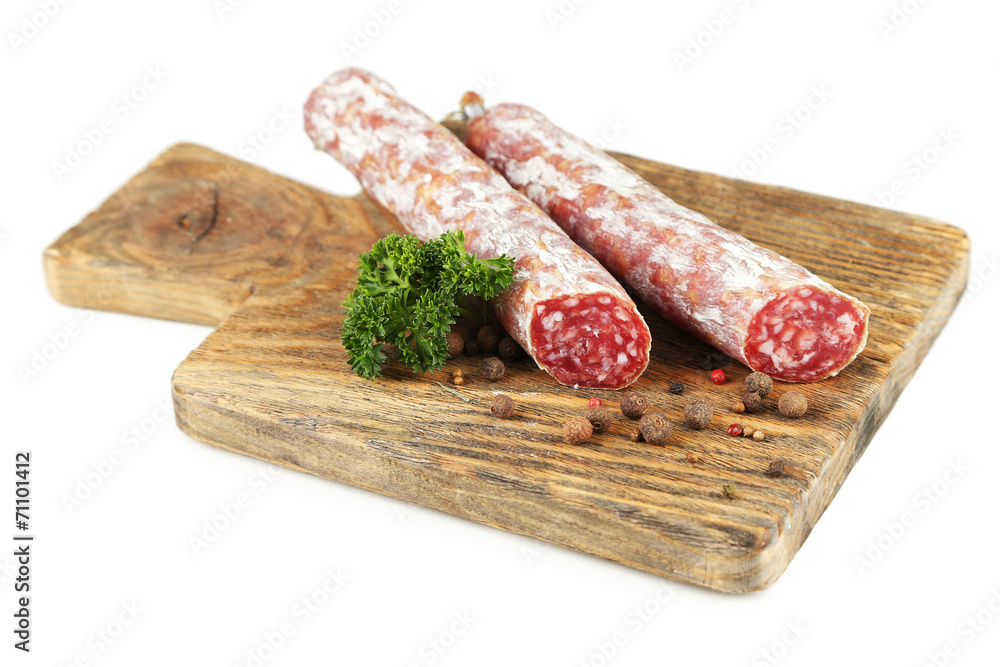 Italian salami on wooden cutting board, isolated on white Italian salami on wooden cutting board, isolated on white