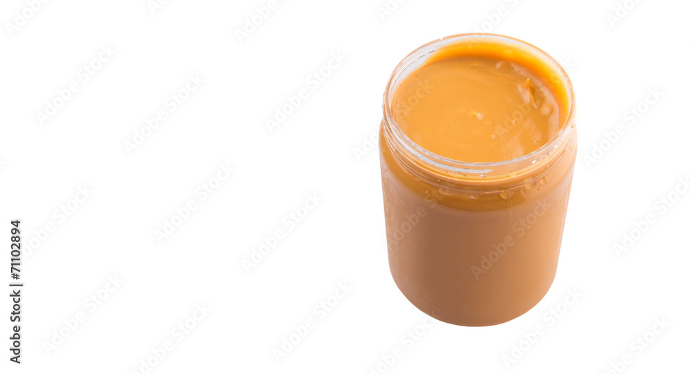 Peanut butter in a jar over white background Peanut butter in a jar over white background