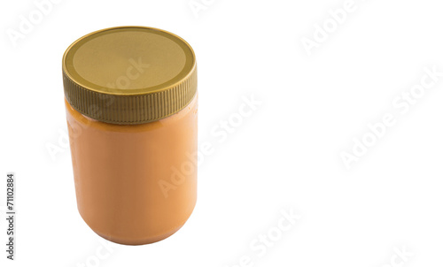 Peanut butter in a jar over white background