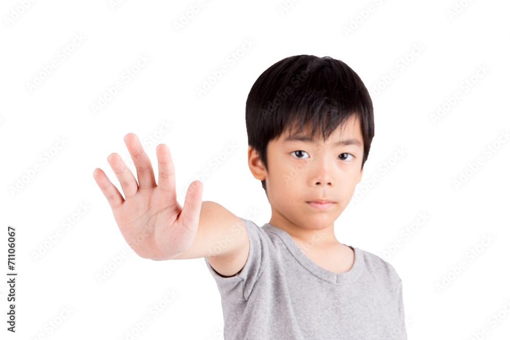 Portrait of a young boy making stop gesture on white background Portrait of a young boy making stop gesture on white background