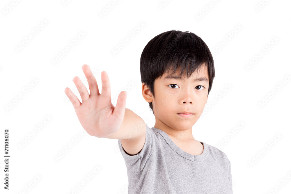 Portrait of a young boy making stop gesture on white background Portrait of a young boy making stop gesture on white background