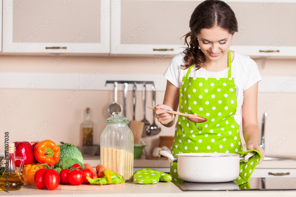 Young Woman Cooking in the kitchen. Healthy Food. Dieting Concep