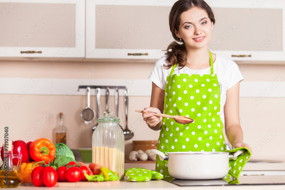 Young Woman Cooking in the kitchen. Healthy Food. Dieting Concep Young Woman Cooking in the kitchen. Healthy Food. Dieting Concep