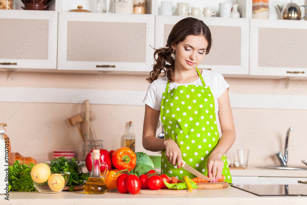 Young Woman Cooking in the kitchen. Healthy Food. Dieting Concep