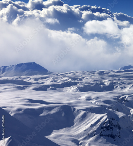 Snowy sunlight plateau and sky with clouds © BSANI