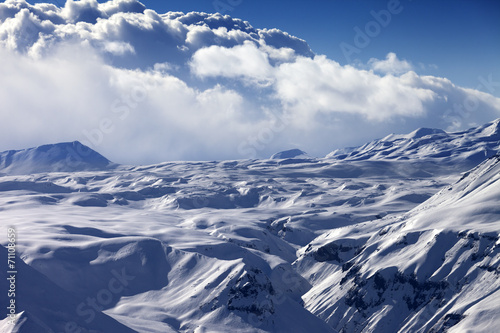 Snowy sunlight plateau and blue sky with clouds