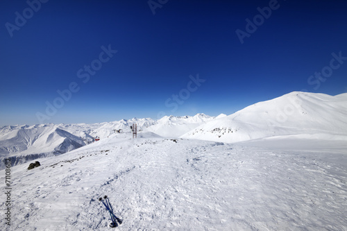 Ski poles on snow slope at nice day