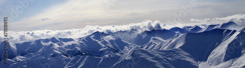 Panorama of evening mountains in clouds