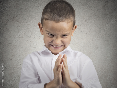 sly scheming child boy plotting something bad