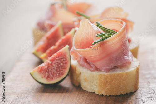 canapes with jamon and figs on table