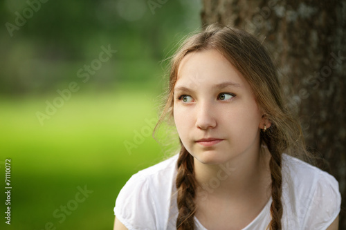 girl sit near tree in park