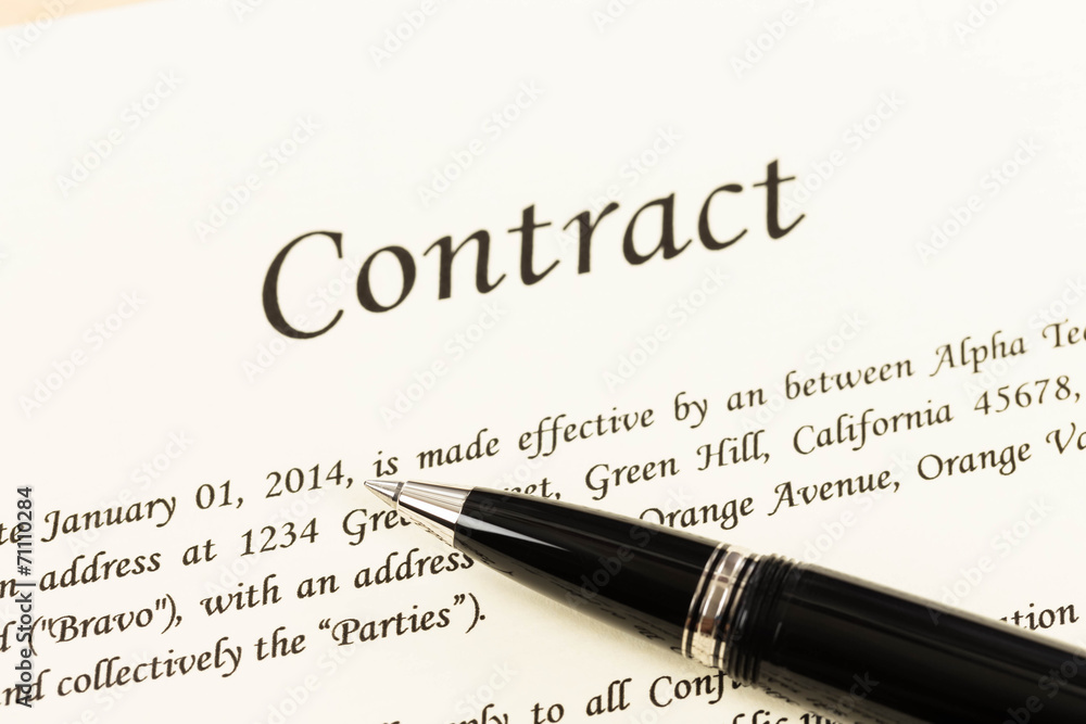 Business contract document on cream color paper focus at pen Business contract document on cream color paper focus at pen