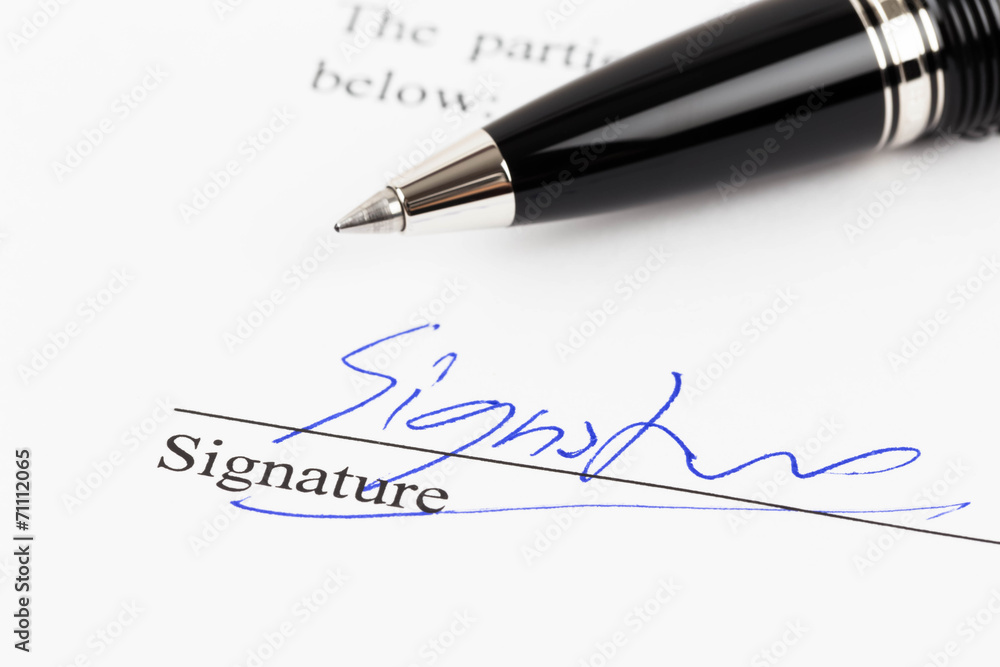 Fototapeta premium Signature on document with pen
