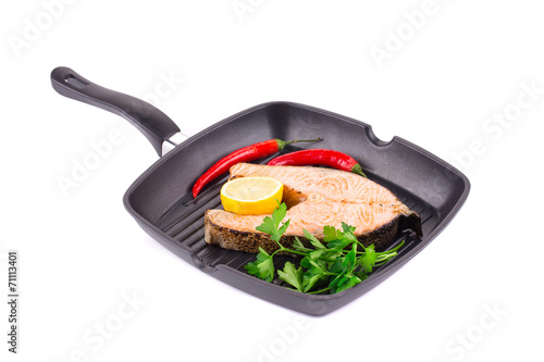 Fried salmon steak on pan.