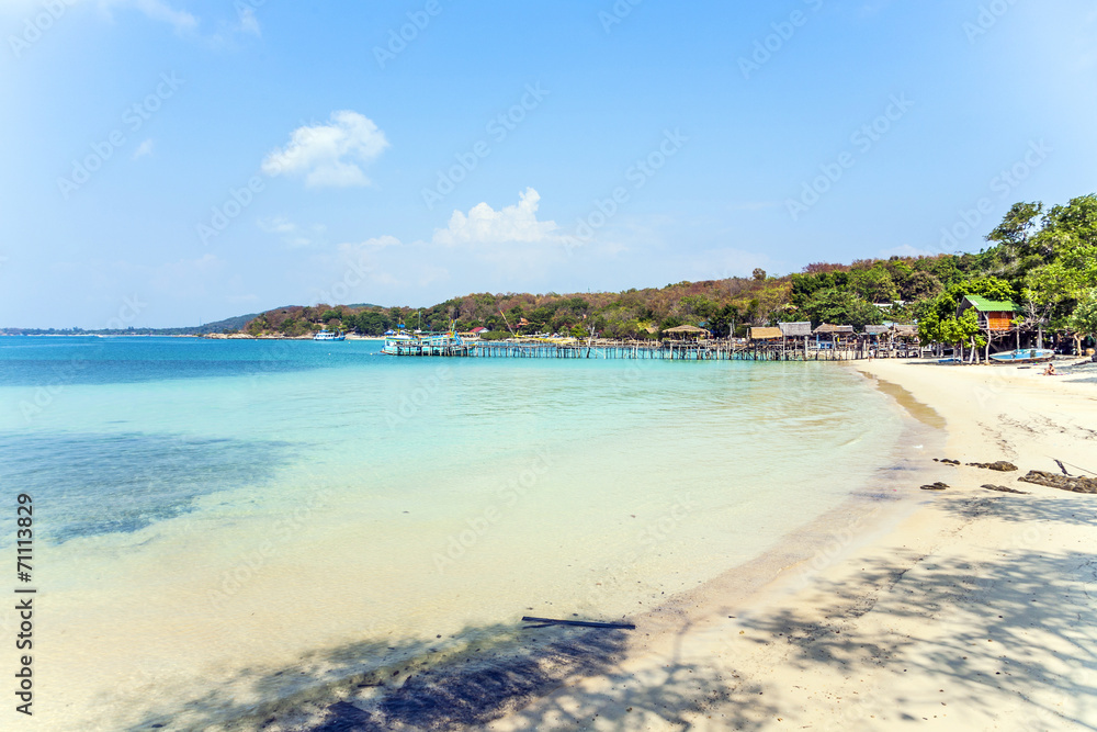 beautiful beach with wooden pier in bay