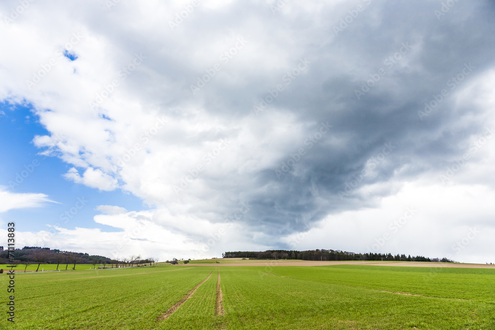 dark clouds over fields in spring dark clouds over fields in spring