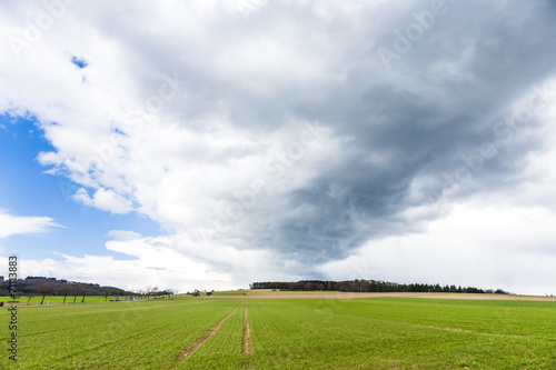 dark clouds over fields in spring