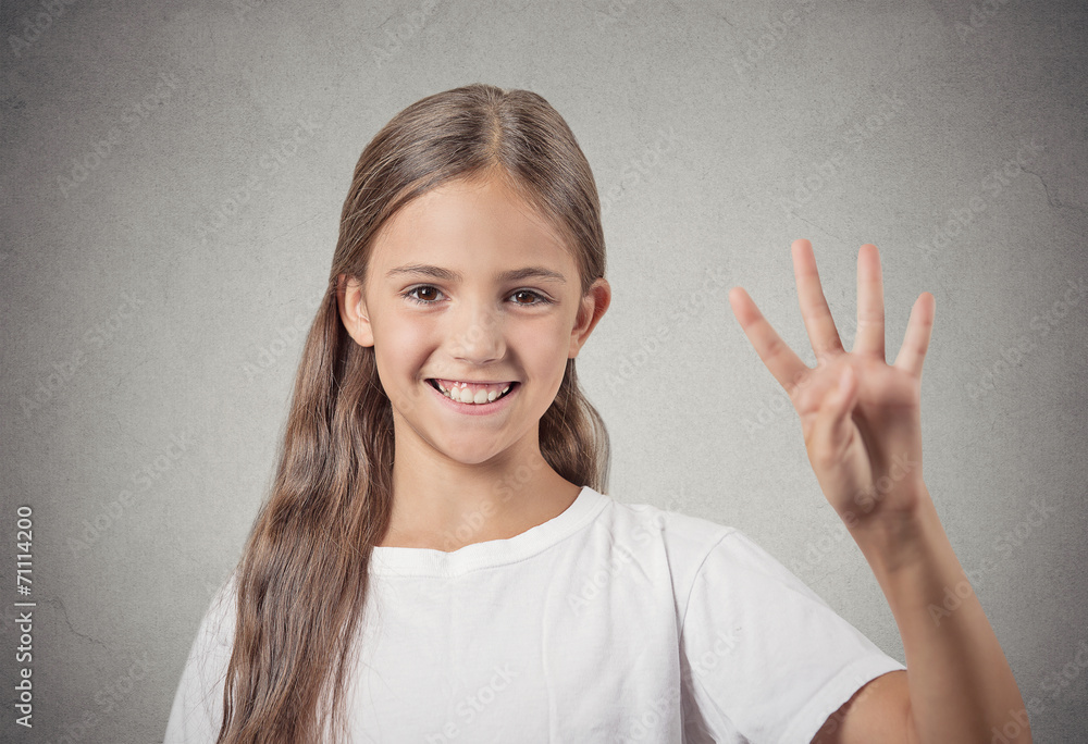 Headshot teenager girl showing 4 fingers on grey background Headshot teenager girl showing 4 fingers on grey background