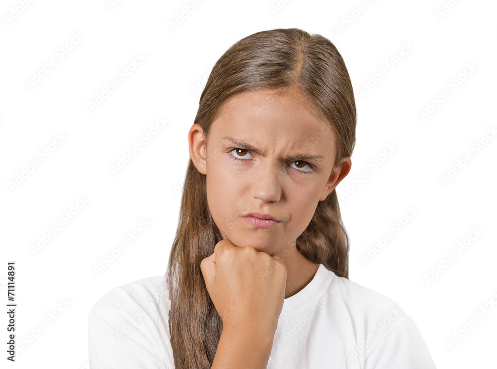 Headshot angry grumpy teenager girl isolated white background Headshot angry grumpy teenager girl isolated white background