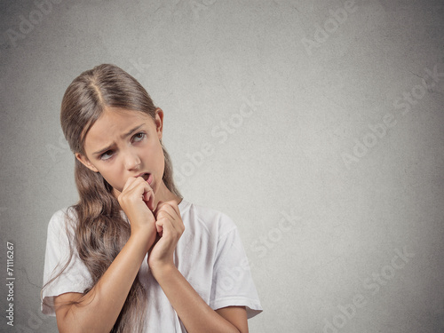 Fotografija Headshot clueless teenager girl sucking thumb on grey background