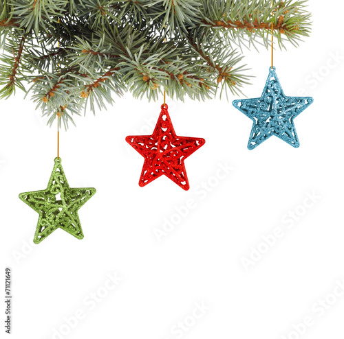 Christmas fir branch with multicoloured, stars on a white back