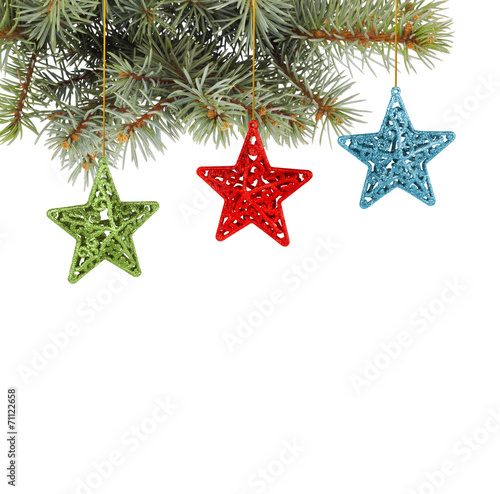 Christmas fir branch with multicoloured, stars on a white back