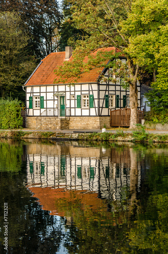 Fachwerkhaus am herbstlichen Fluss bei Muehlheim Ruhr photo