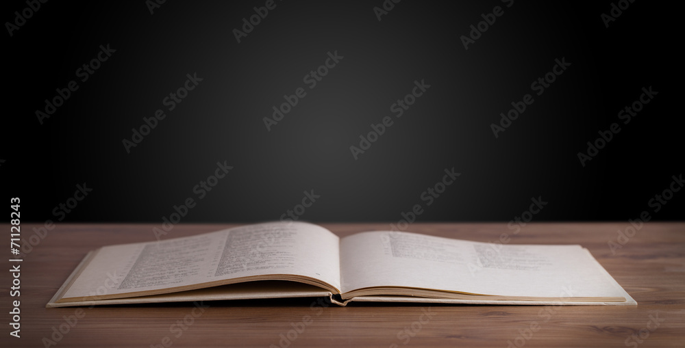 Fototapeta premium Open book on wooden deck