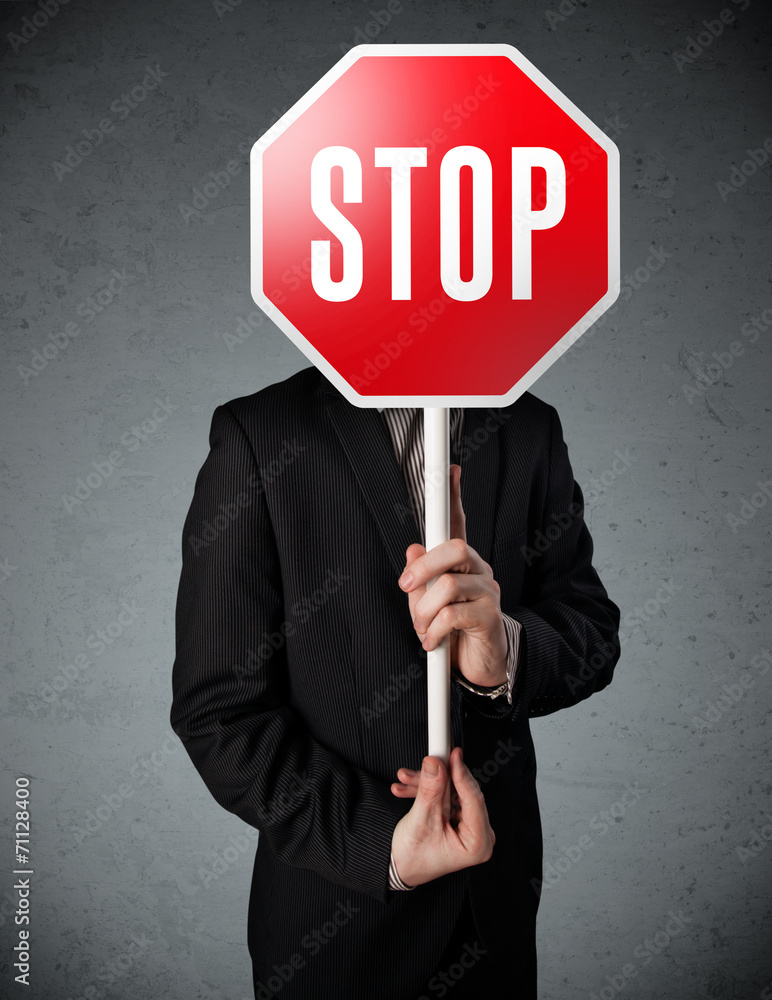 Businessman holding a stop sign Businessman holding a stop sign