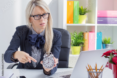 Frustrated business woman is angry about being late at work