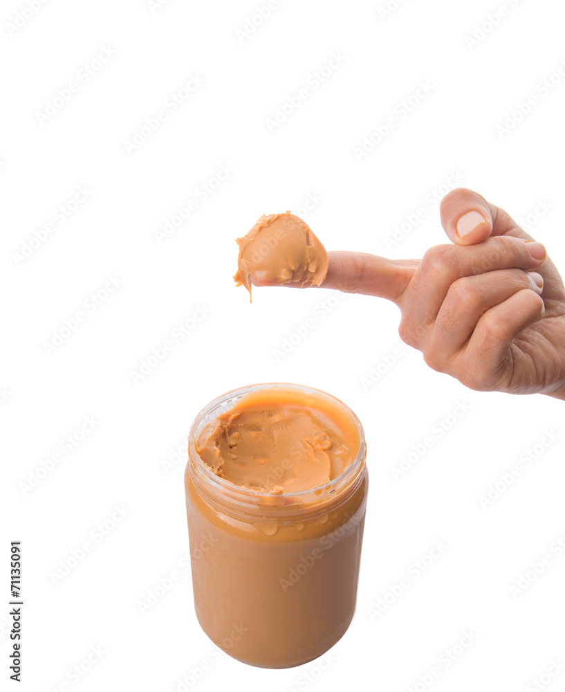 Female finger with peanut butter Female finger with peanut butter