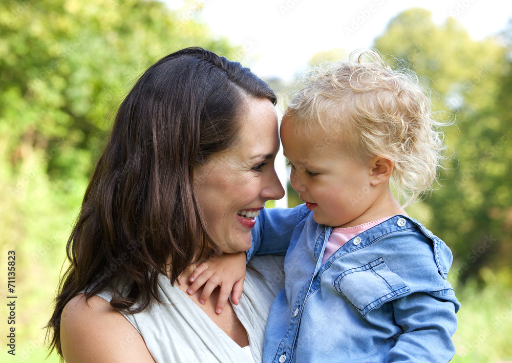 Happy mother and baby smiling face to face Happy mother and baby smiling face to face