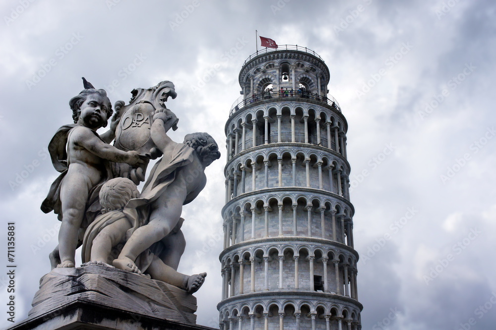 Statues of cherubs angel and Leaning Tower in Pisa, Italy