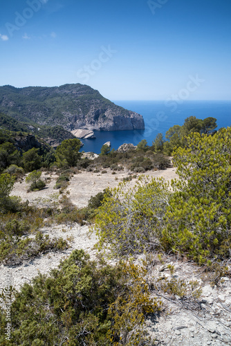 Landscape image of S'Aguila bay cove on Mediterranean island of