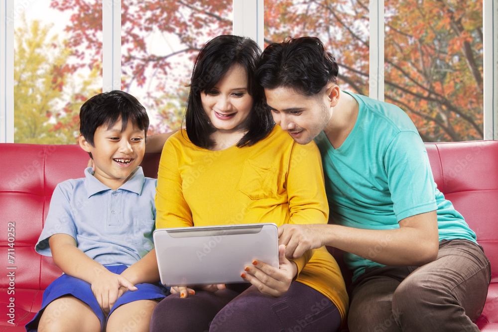 Hispanic family using digital tablet Hispanic family using digital tablet