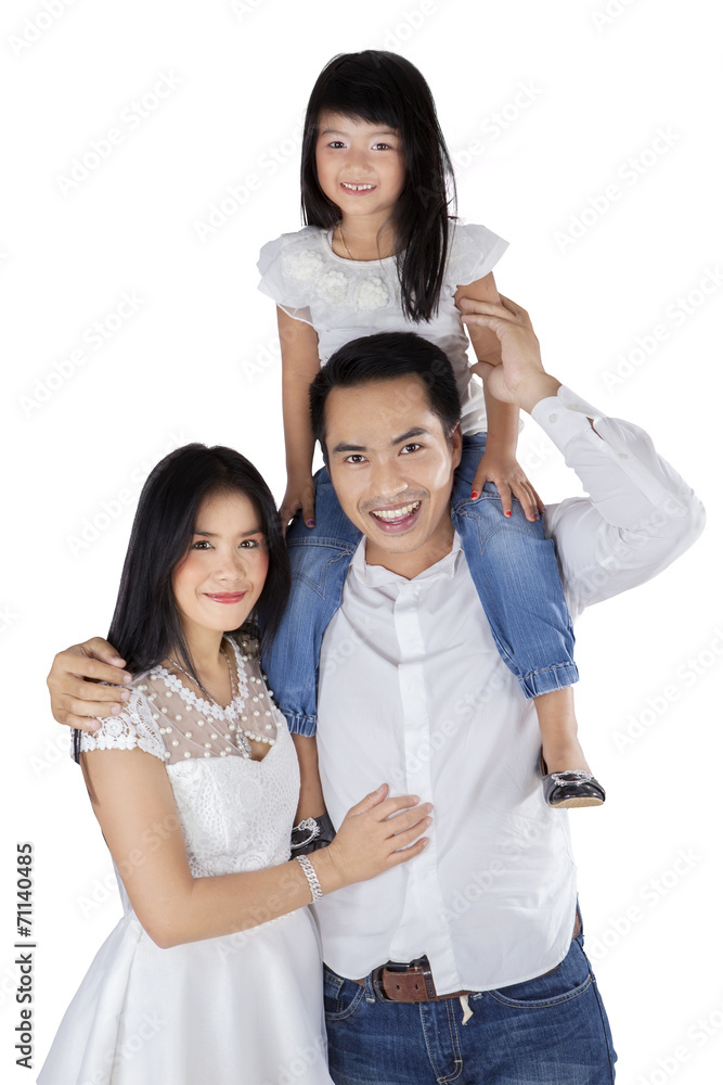 Joyful family smiling at camera in studio Joyful family smiling at camera in studio