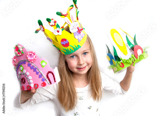 Fotografie Little girl demonstrating her craft works and Easter bonnet