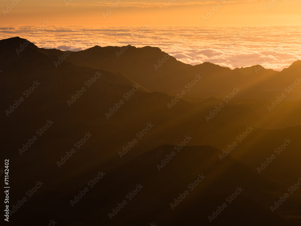 Beams of the rising sun over Haleakala volcanic crater on Maui