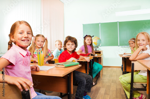 Desk rows with boys and girls sitting in classroom