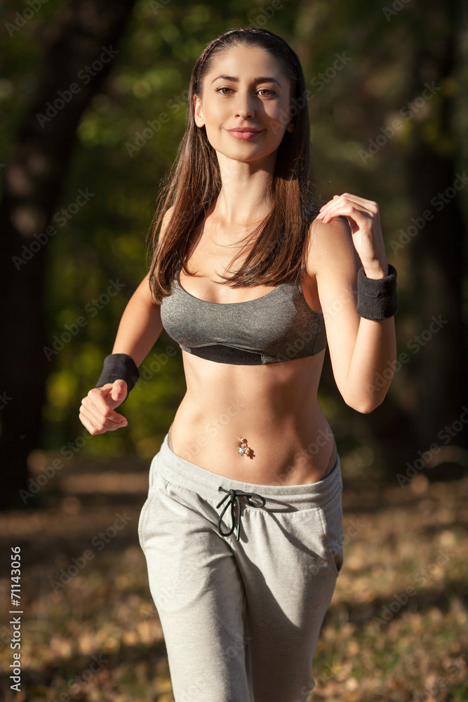 woman running outdoors training for marathon run woman running outdoors training for marathon run