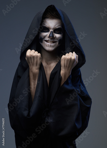 Teen with makeup skull shows fists