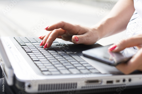 Hands of a businesswoman typing on a computer keyboard