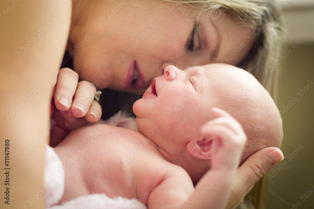 Young Beautiful Mother Holding Her Precious Newborn Baby Girl