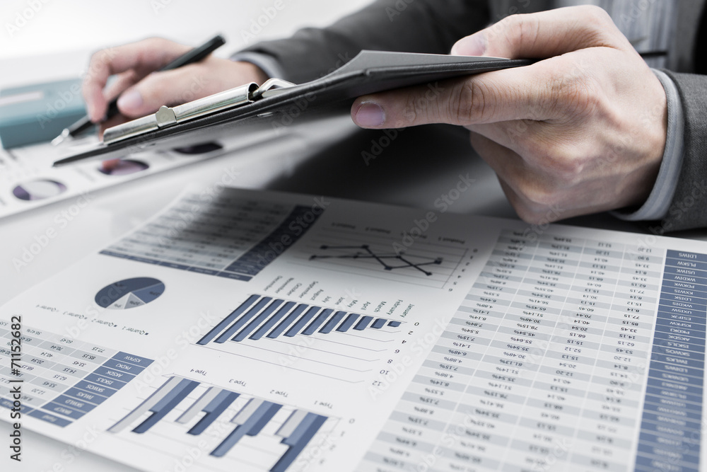 Businessman analyzing investment charts. Accounting Businessman analyzing investment charts. Accounting