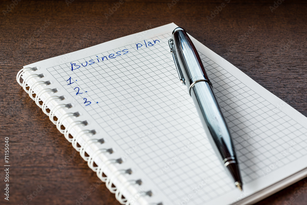 Drawing up the business plan, write in the notebook Drawing up the business plan, write in the notebook